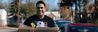 Sgt. Edgar Leon holds a box of food