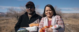The Hill family holding food.