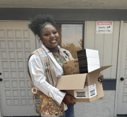 Jade holds a box.