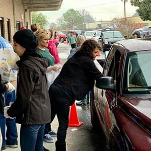 Volunteers and staff at Harvest Hope Food Bank in Richland County, South Carolina, distribute food at a drive-up distribution.