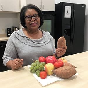 Earline poses with produce