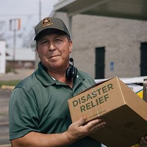 Man holding a disaster box.