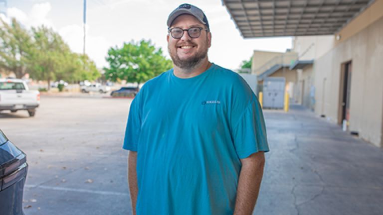 Robert standing outside of a food distribution location.