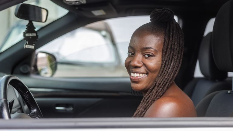 Shelby in a car and smiling.
