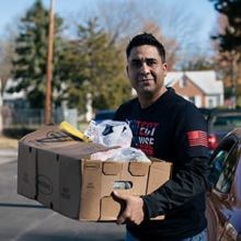A veteran in Richmond, VA with a box of food