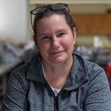 A woman smiling at the camera.