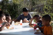 Robert shares a meal with his grandchildren