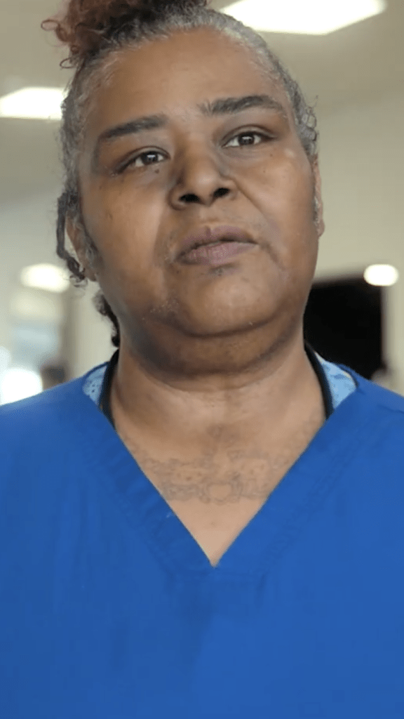 An older woman in scrubs
