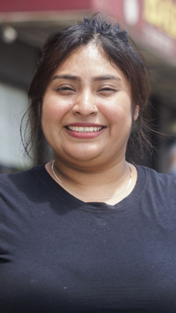 A woman wearing a black shirt smiling
