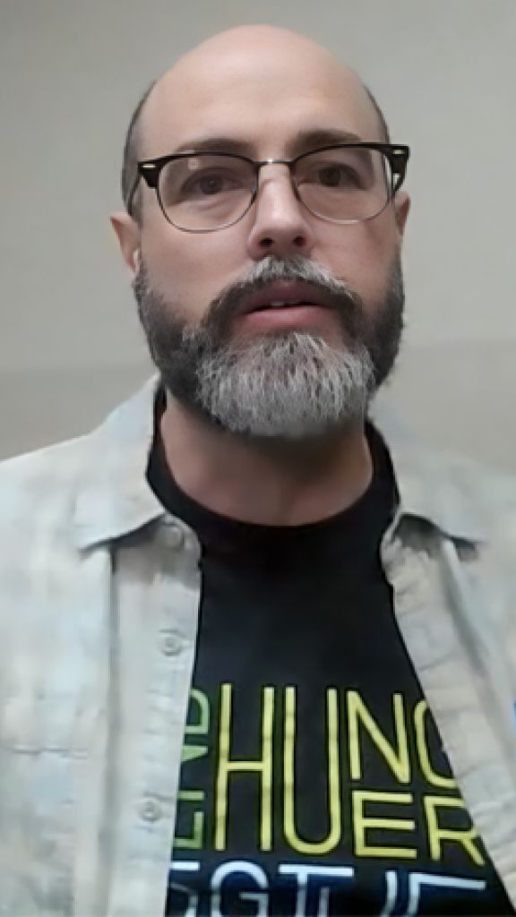 A person with a beard and glasses