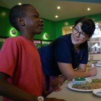 A Registered Dietitian interacting with a client at a health fair.