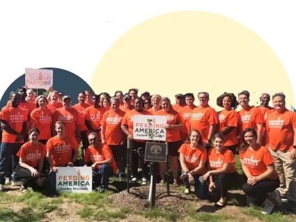 A large group of people wearing bright orange Feeding America t-shirts